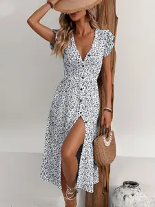 Detail view of a white floral V-neck midi dress with a stylish front slit and buttons