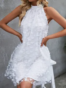 Detail shot of a white sleeveless French dress featuring elegant 3D butterfly appliqués