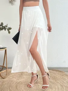 Elegant white double-layered mesh maxi skirt featuring a high side slit detail