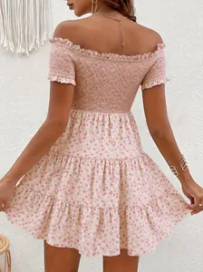 Back view of pink floral off-shoulder dress with smocked bodice and tiered ruffles