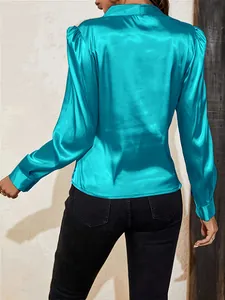 Detailed back view of a turquoise satin blouse with elegant puff lantern sleeves
