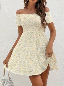 Detail of a vintage yellow floral off-shoulder mini dress with smocked bodice design
