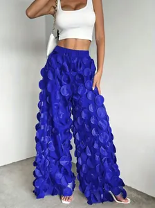 Detailed view of women's blue mesh wide-leg pants with 3D floral circle texture