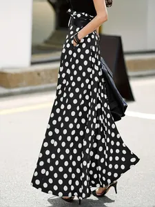 Detailed side profile of high-waisted black and white polka dot wide-leg culottes