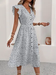 Close-up of a white V-neck midi dress with black floral print and stylish flutter sleeves.
