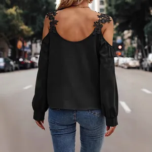 Elegant black cold-shoulder blouse with intricate floral lace straps for stylish women