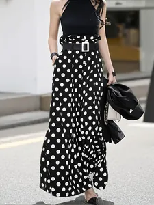 Elegant high-waisted polka dot wide-leg culottes for women in street style fashion.
