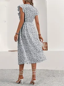 Back view of a chic white floral midi dress with a cinched waist and short sleeves.