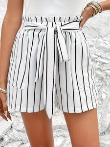 Close-up of white vertical striped high-waisted shorts with a stylish tie belt detail.