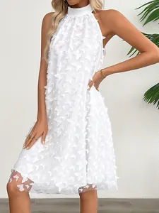Detailed shot of a white French-style sleeveless halter dress with 3D butterfly appliqués
