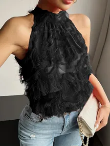 Close-up of black mesh halter neck top with layered fringe tassels and textured fabric