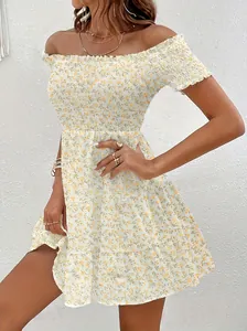 Detailed view of women's vintage yellow floral off-shoulder dress with smocked waist