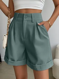 Detailed view of high-waisted pleated wide-leg summer shorts in dark teal with pockets