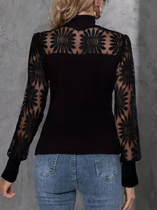 Detail view of women's black long sleeve top with elegant floral lace embroidery on the back