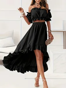 Detailed view of black off-shoulder ruffle crop top and high-low maxi skirt set