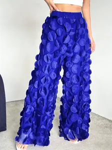 Detail view of royal blue mesh wide-leg pants with 3D fabric petal embellishments