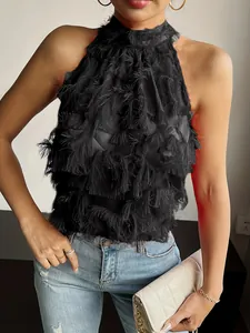 Detailed view of black sleeveless halter-neck top featuring romantic fringe textures