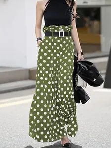 Stylish high-waisted polka dot wide-leg trousers styled with a black halter top