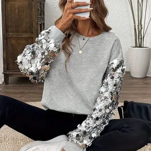 Elegante felpa grigia da donna con maniche di paillettes argento per le festività