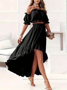 Detail view of elegant black high-waisted asymmetrical maxi skirt and ruffle crop top set