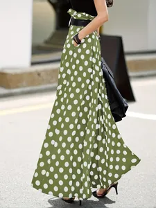 Detail view of stylish olive green high-waist polka dot culottes with flowy drape