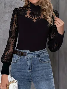 Macro view showing intricate black lace floral embroidery on this long sleeve top