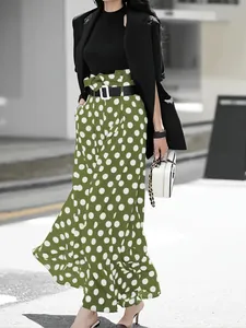 Macro detail of high-waisted green and white polka dot culottes with black belt