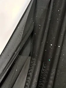 Macro view of black double-layer mesh fabric with glittering starry sequin details