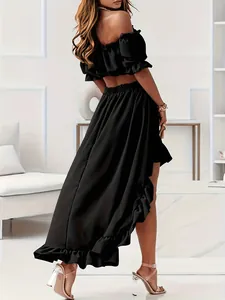 Elegant black two-piece set featuring off-shoulder top and high-low ruffled maxi skirt