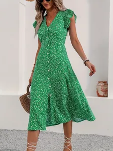 Detailed view of the green ditsy floral V-neck midi dress with ruffled sleeves.