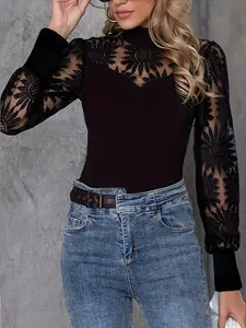 Detailed view of women's sexy black lace top with floral embroidery and mesh sleeves
