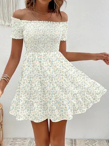 Close-up detail showing the vintage floral print and smocked off-shoulder dress design.