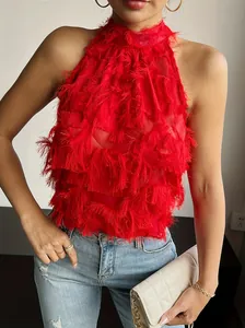 Detailed macro view of red sleeveless halter neck top with fringe and tassel mesh