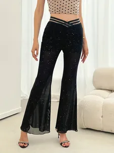 Detailed view of high-waist black mesh flared pants with silver glitter dots