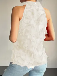 Detailed back view of a white sleeveless high-neck top with romantic fringe textures.