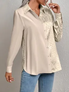 Detailed macro shot of elegant champagne leopard print jacquard blouse with button closure.
