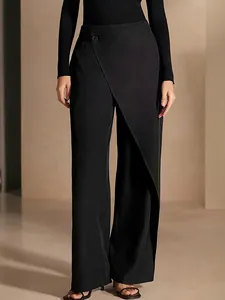 Detail of high-waisted asymmetrical wide-leg trousers in elegant black woven fabric
