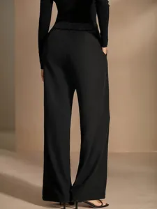 Back view of elegant black high-waisted wide-leg trousers with smooth drape