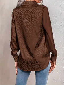Close-up back view of elegant leopard print long-sleeve shirt with patchwork fabric details