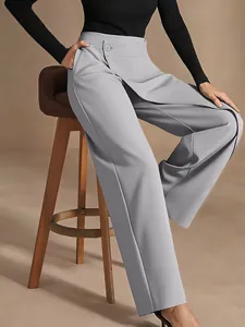 Detail view of light grey high waisted trousers with asymmetrical button waist design.