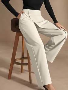 Close-up of beige wide-leg trousers featuring unique asymmetrical high waist and drape.