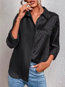 Detail of elegant black long sleeve shirt with split leopard print and polo collar
