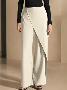 Detailed view of elegant cream high-waisted asymmetric wrap wide-leg suit trousers