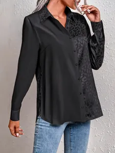 Detail of black long sleeve shirt featuring leopard print splice and silky texture.