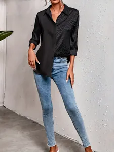 Detail view of an elegant black shirt with leopard print patchwork for women.