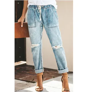 Women's light wash distressed straight-leg jeans with elastic drawstring waist on model.