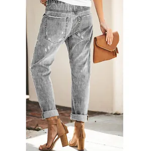 Back view of grey distressed straight-leg denim pants with elastic waist and cuffed hem