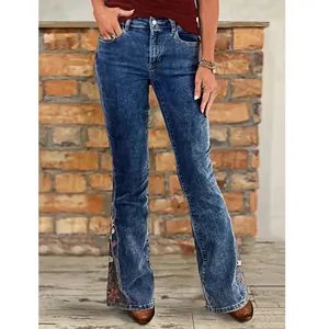 High-waisted flared denim jeans with intricate floral embroidery details at the hem
