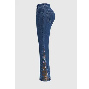 Side view of blue flare jeans featuring detailed floral embroidery on the lower leg.