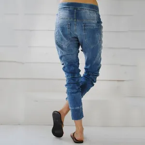Detailed back view of women's loose denim harem pants with elastic waist and pockets